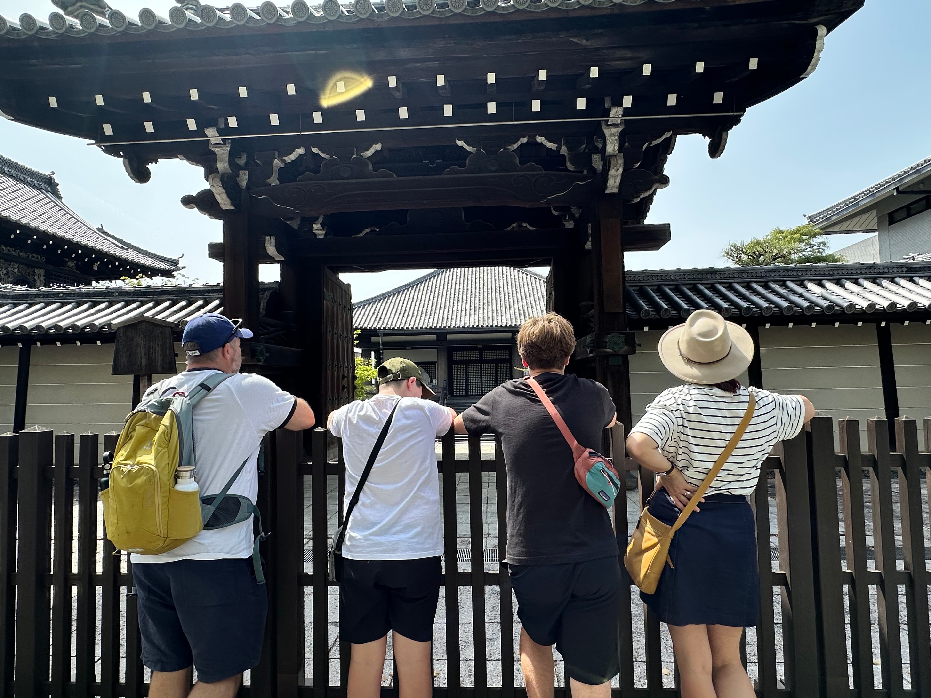 Guests standing beneath the red torii gates of Fushimi Inari Shrine during a private Kyoto walking tour.